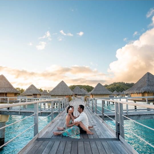 Couple and overwater bungalows in Bora Bora