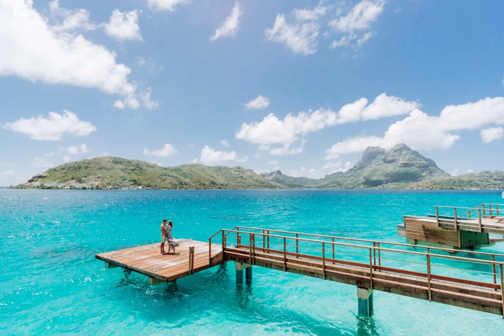 A couple standing on an overwater platform in Bora Bora