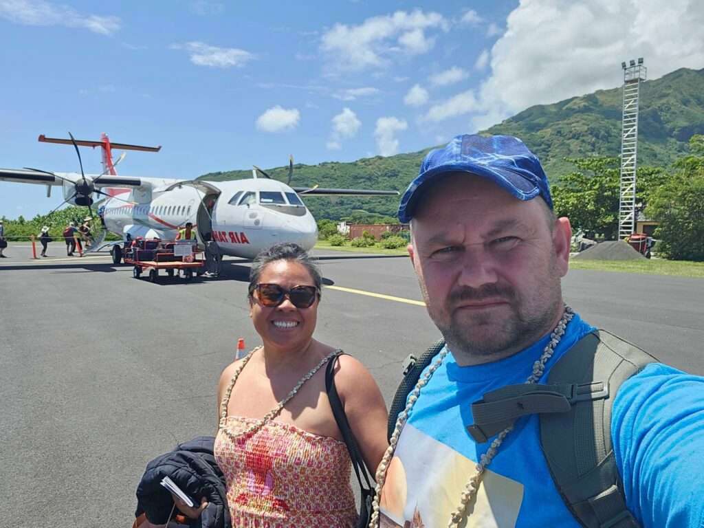 Couple posing in front of an Air Tahiti plane