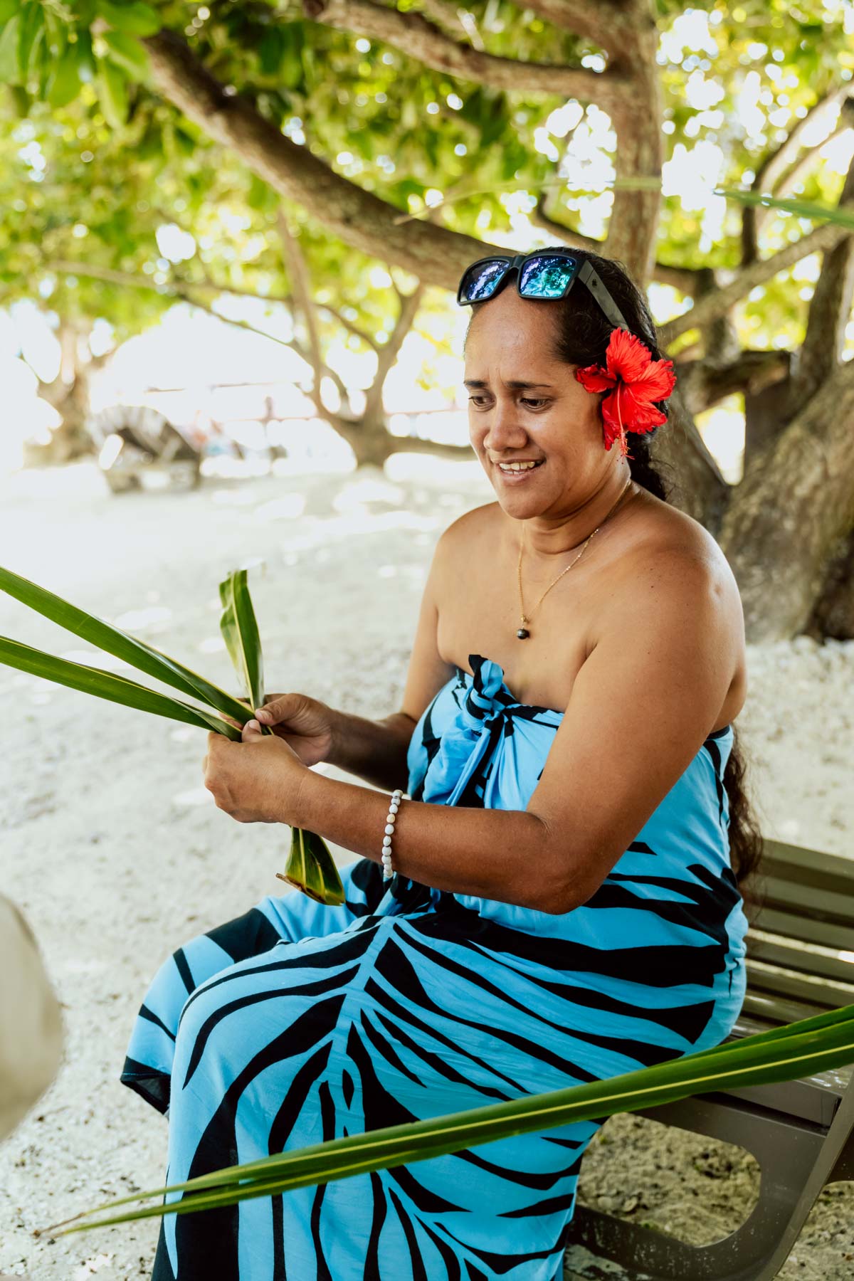 Polynesian woman braiding a palm
