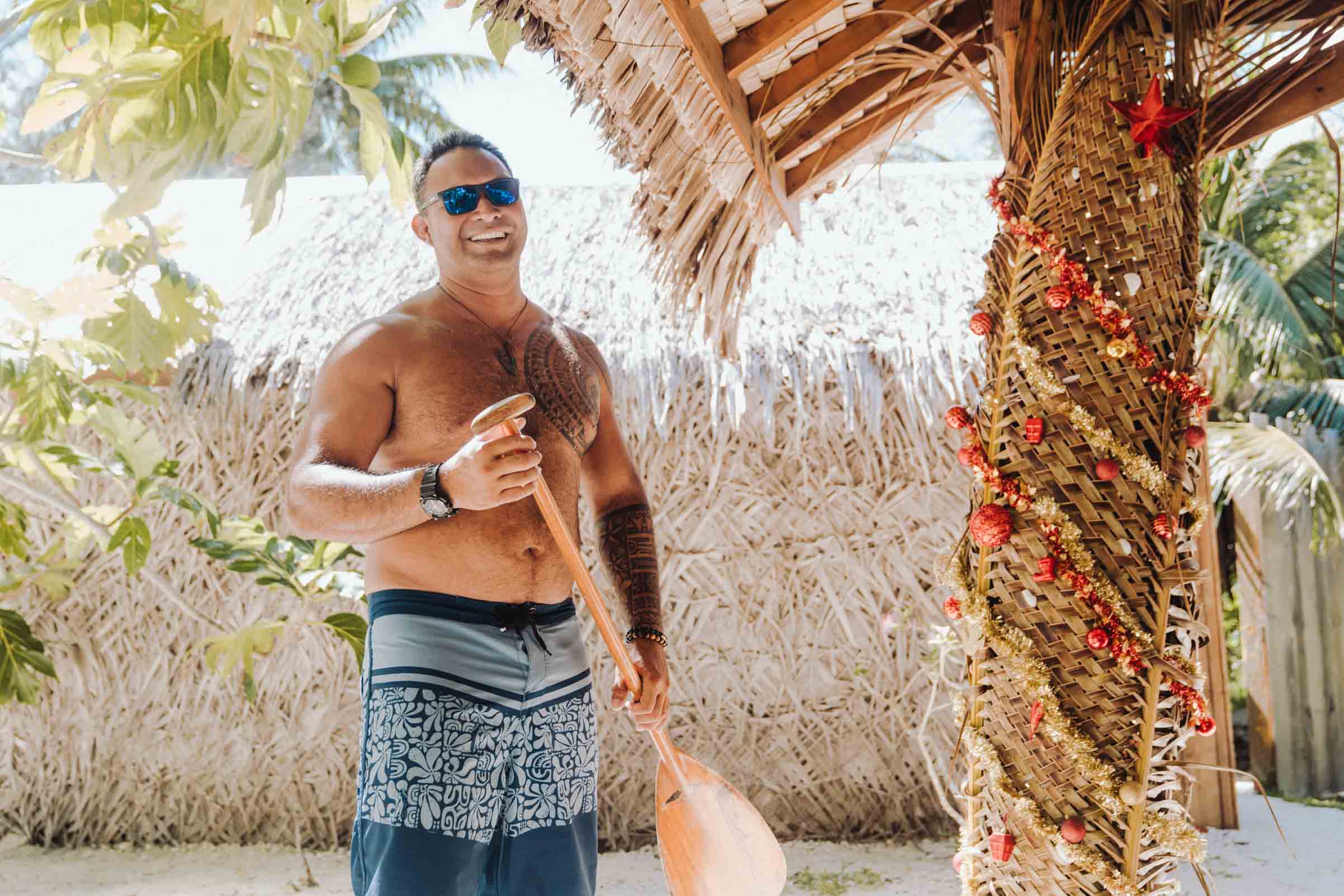 Polynesian Man holding a va'a paddle