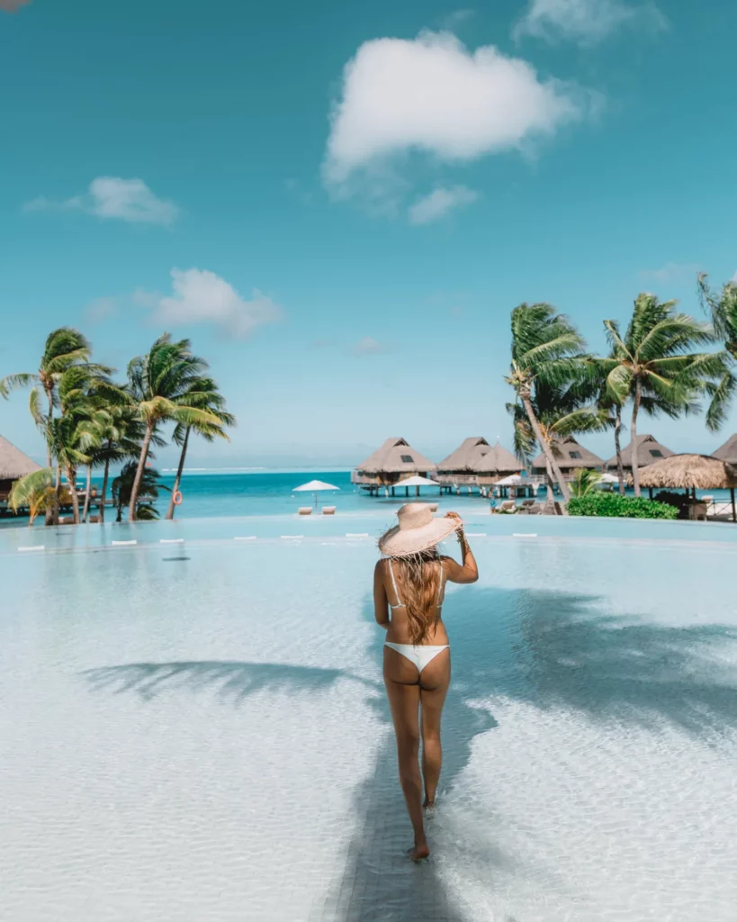 a woman standing on the pool of the Conrad Bora Bora Nui 
