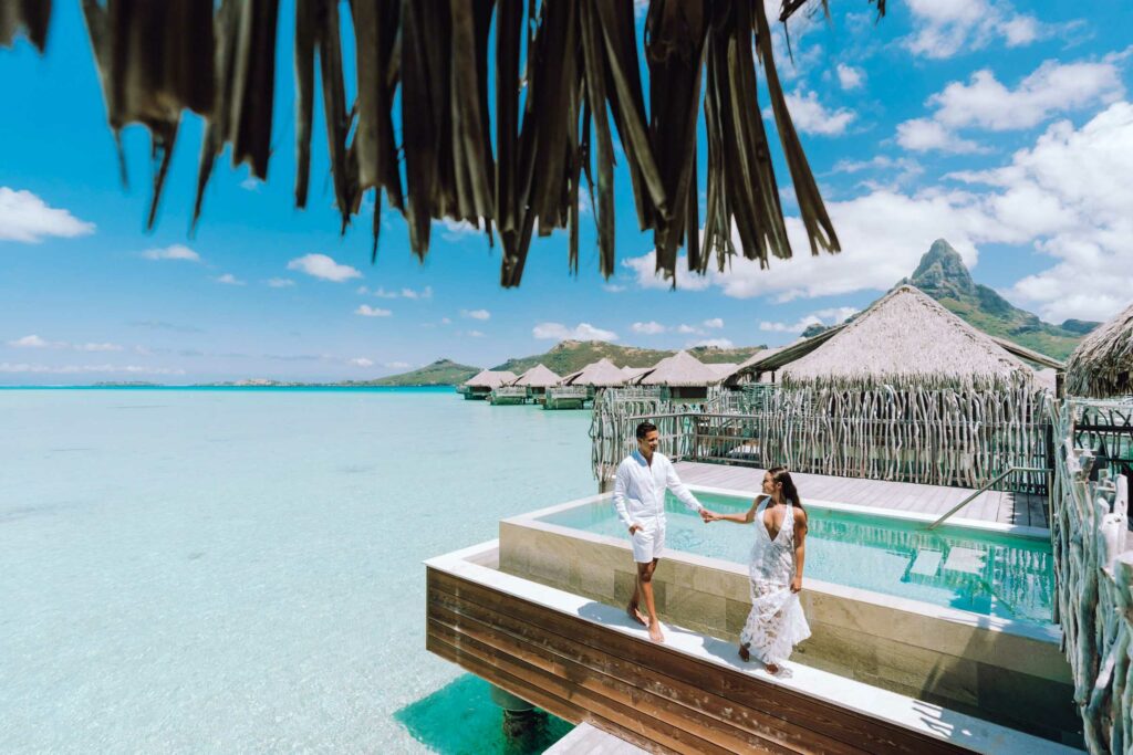 Couple standing on an Overwater bungalow in Bora Bora