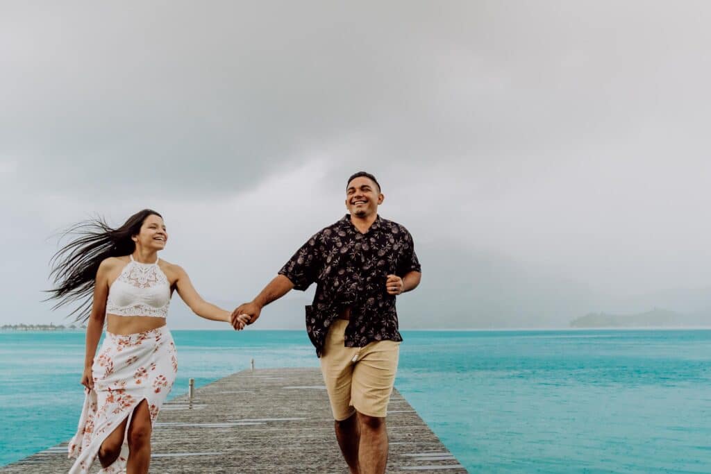 Couple running under the rain in Bora Bora