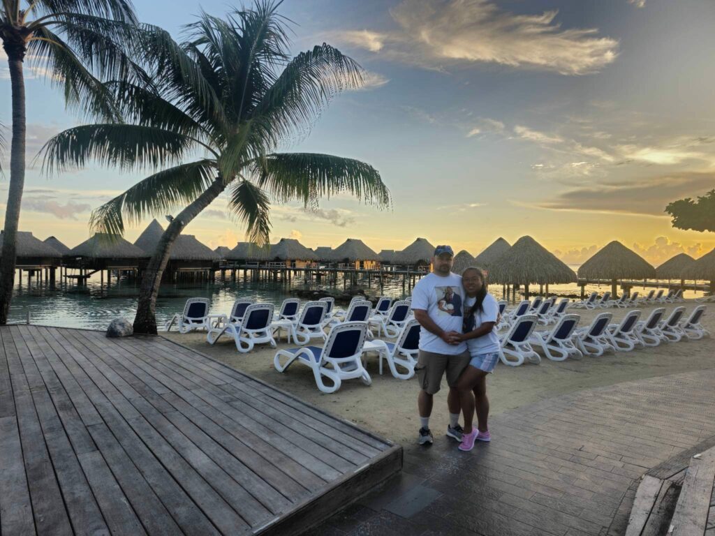 Couple posing on the beach of the Hilton resort in Moorea