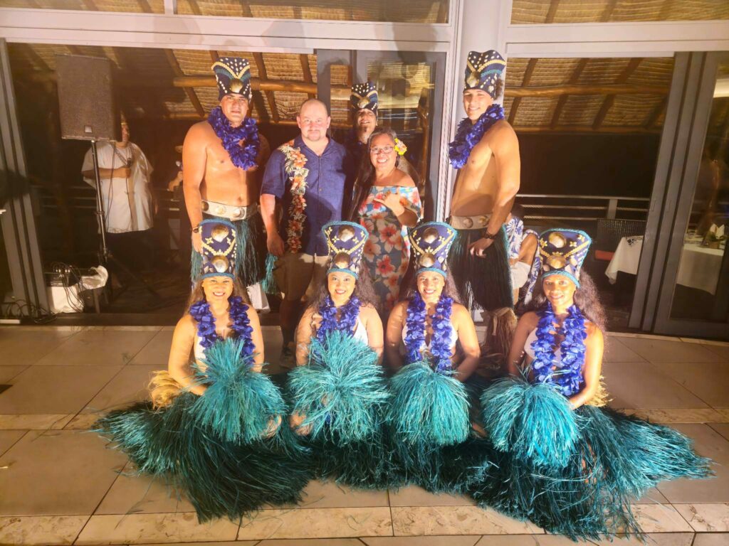 Couple posing with Polynesian dancers