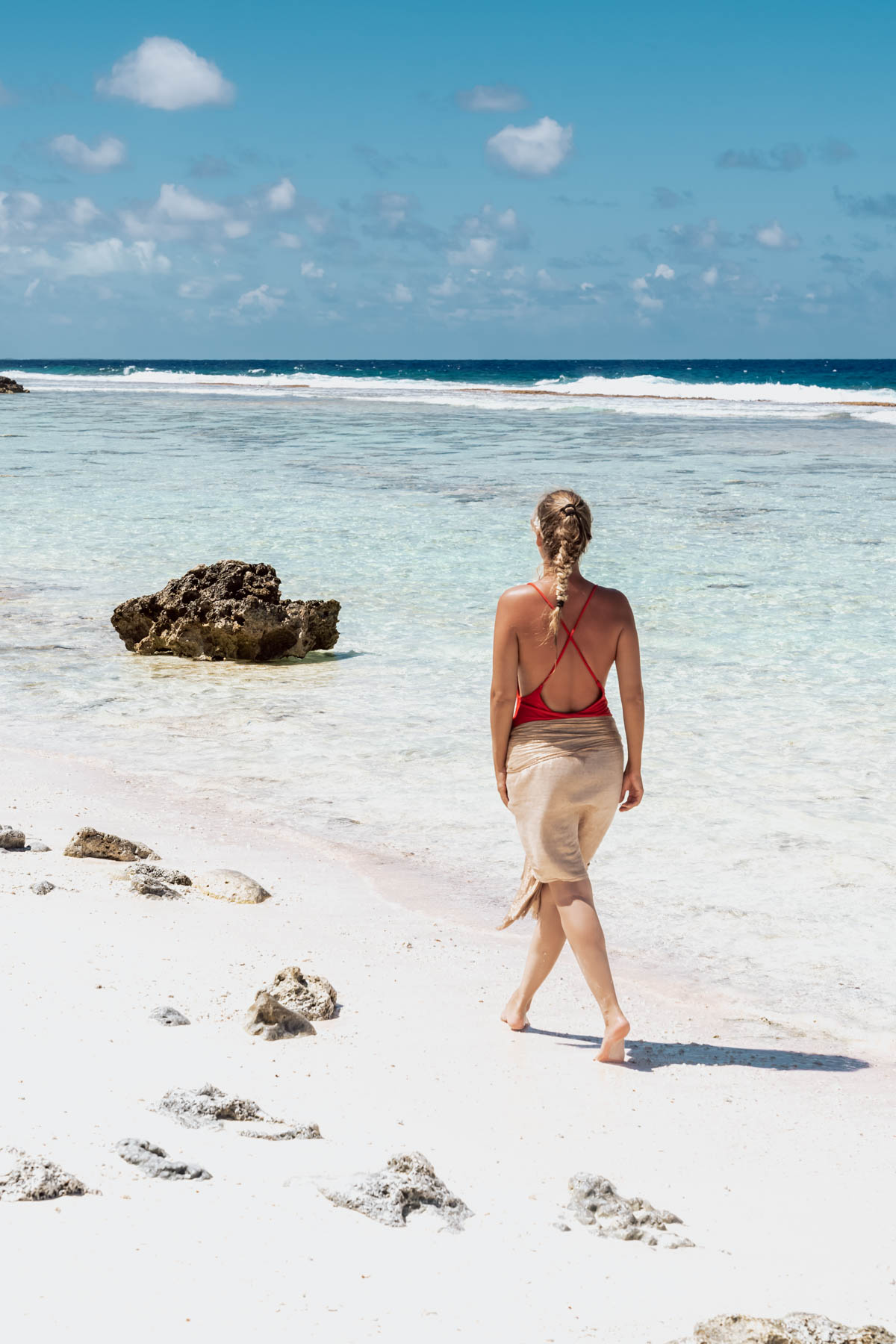 Woman walking on the beach in Bora Bora