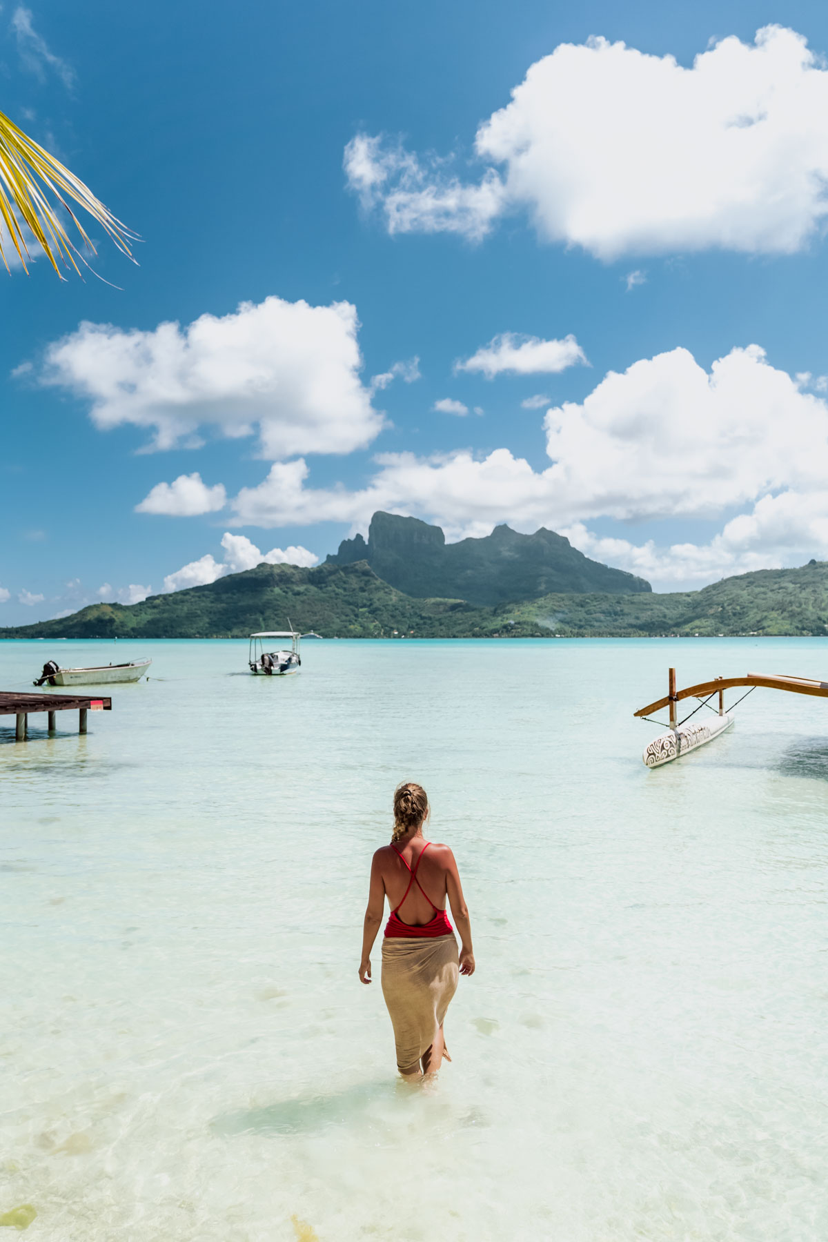 View on lagoon and mountain from a motu in Bora Bora with a woman