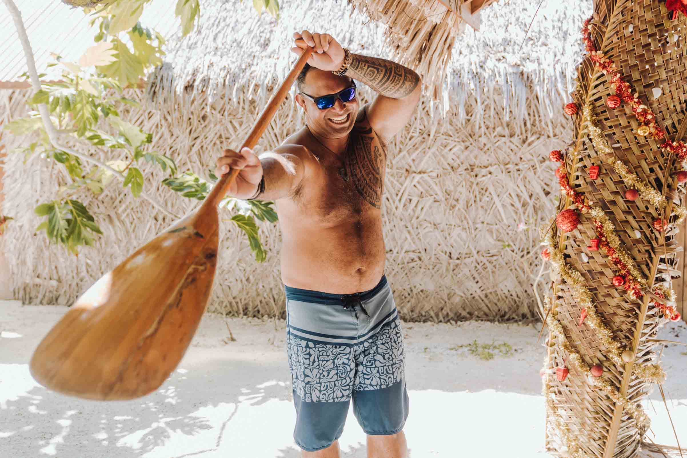Polynesian Man holding a va'a paddle